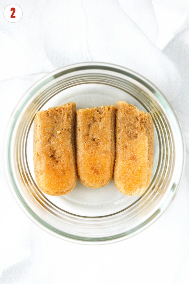 Espresso-soaked ladyfingers in a small round dish for high protein tiramisu.