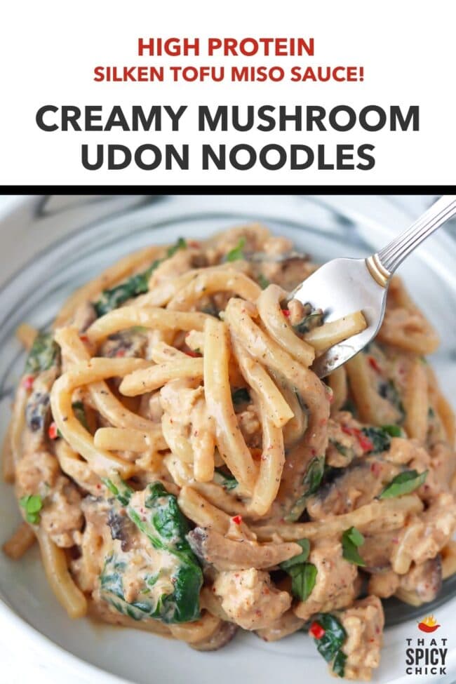 Fork in a plate with creamy mushroom udon noodles. Text overlay "High Protein Silken Tofu Miso Sauce!", "Creamy Mushroom Udon Noodles" and "That Spicy Chick".