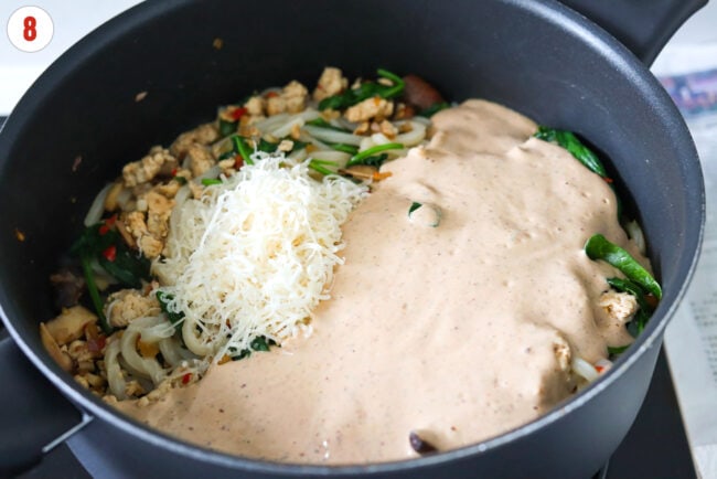 Grated parmigiano reggiano cheese and blended silken tofu miso sauce in a skillet with sautéed chicken, mushrooms, baby spinach and udon noodles.