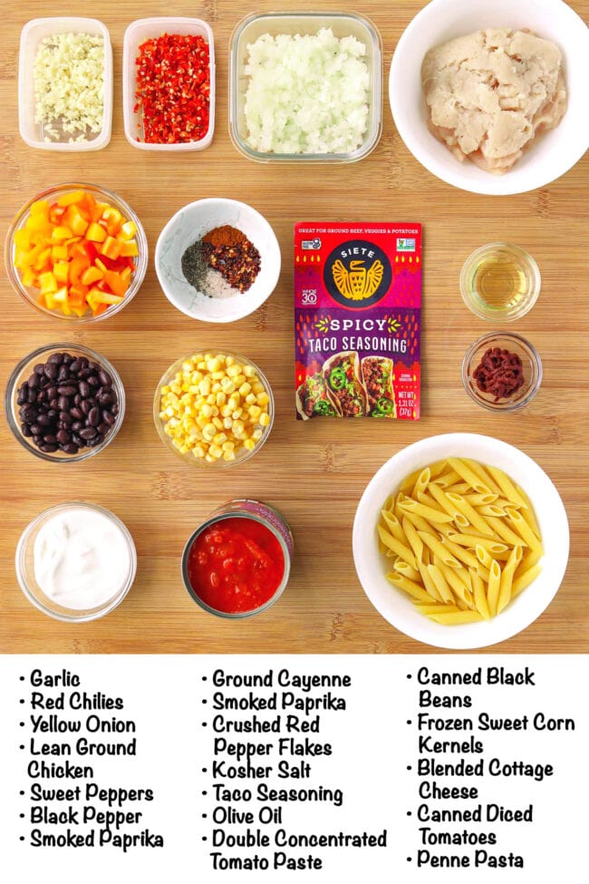 Labeled ingredients fro High Protein Chicken Taco Pasta on a wood board.