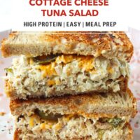 High protein tuna salad sourdough sandwich with cheddar stacked on a light pink plate. Text overlay "Cottage Cheese Tuna Salad", "High Protein | Easy | Meal Prep", and "That Spicy Chick".