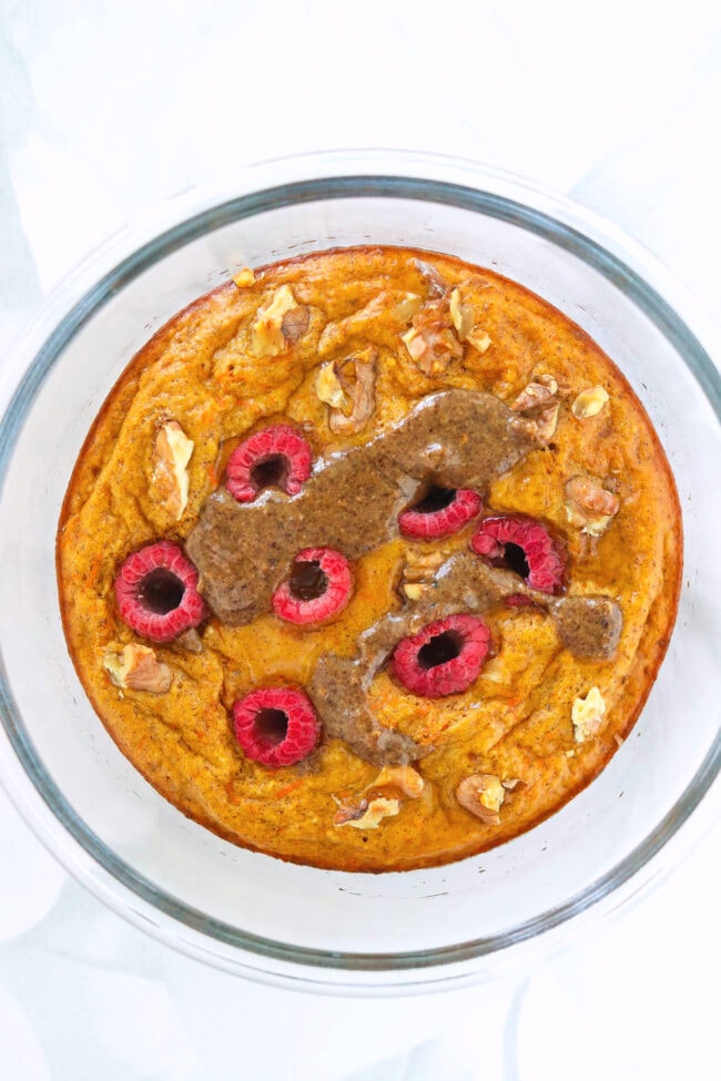 Carrot Cake Protein Pancake Bowl with raspberries, chopped walnuts, pancake syrup and pecan butter.