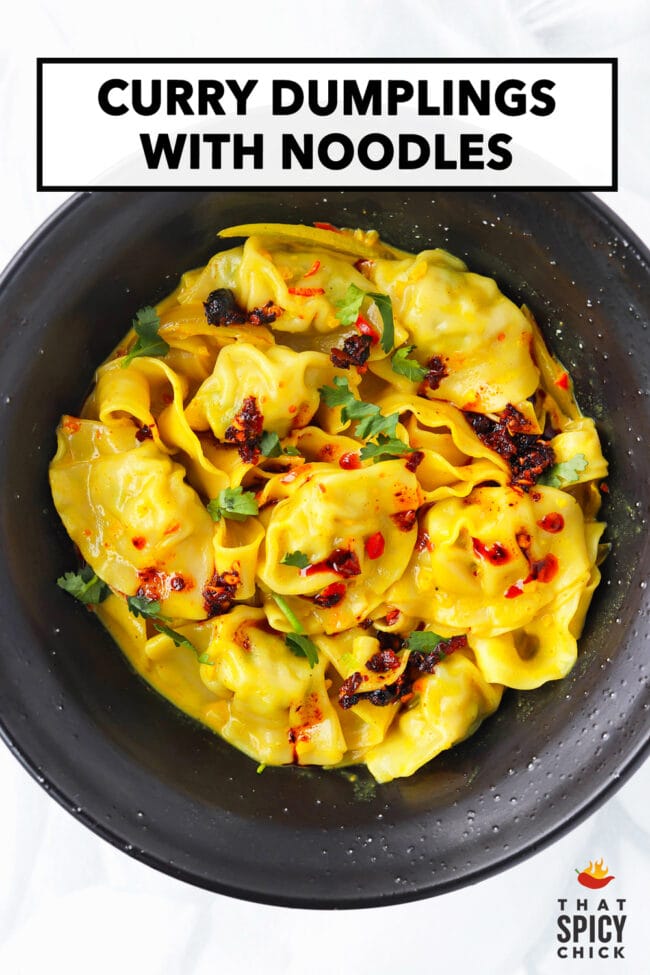 Bowl with curry dumplings with noodles topped with chili crisp and coriander. Text overlay "Curry Dumplings with Noodles" and "That Spicy Chick".