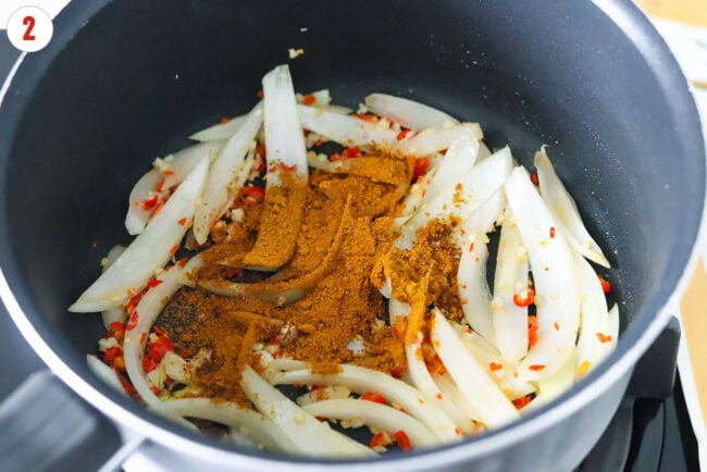 Added curry powder to pot with sautéed onion, garlic and chilies.