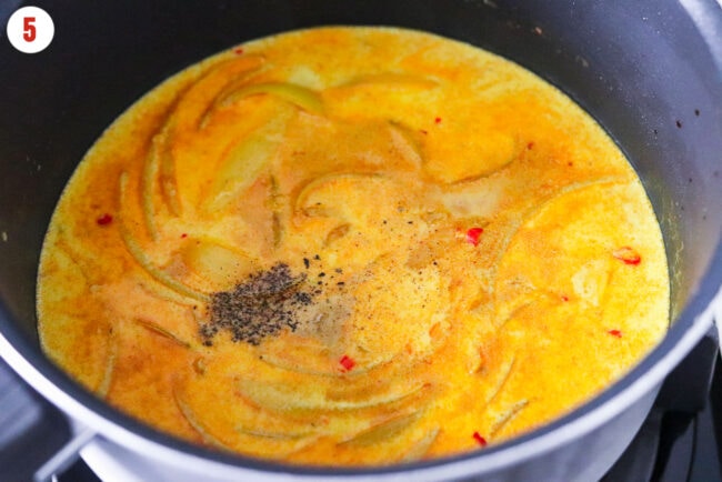 Seasonings added to pot with coconut milk curry sauce.