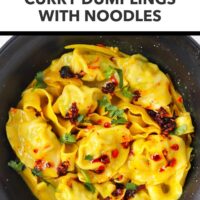 Black bowl with curry sauce dumplings and noodles topped with chili crisp and cilantro. Text overlay "Easy Weeknight Dinner!", "Curry Dumplings with Noodles" and "That Spicy Chick".