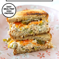 Healthy salmon salad sandwich with melted cheddar and pickled jalapeños on a plate. Text overlay "Cottage Cheese Salmon Salad", "Easy Meal Prep High Protein!" and "That Spicy Chick".