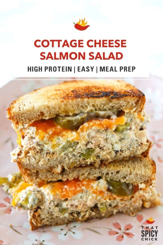 High protein salmon salad sourdough sandwich with cheddar stacked on a light pink plate. Text overlay "Cottage Cheese Salmon Salad", "High Protein | Easy | Meal Prep", and "That Spicy Chick".