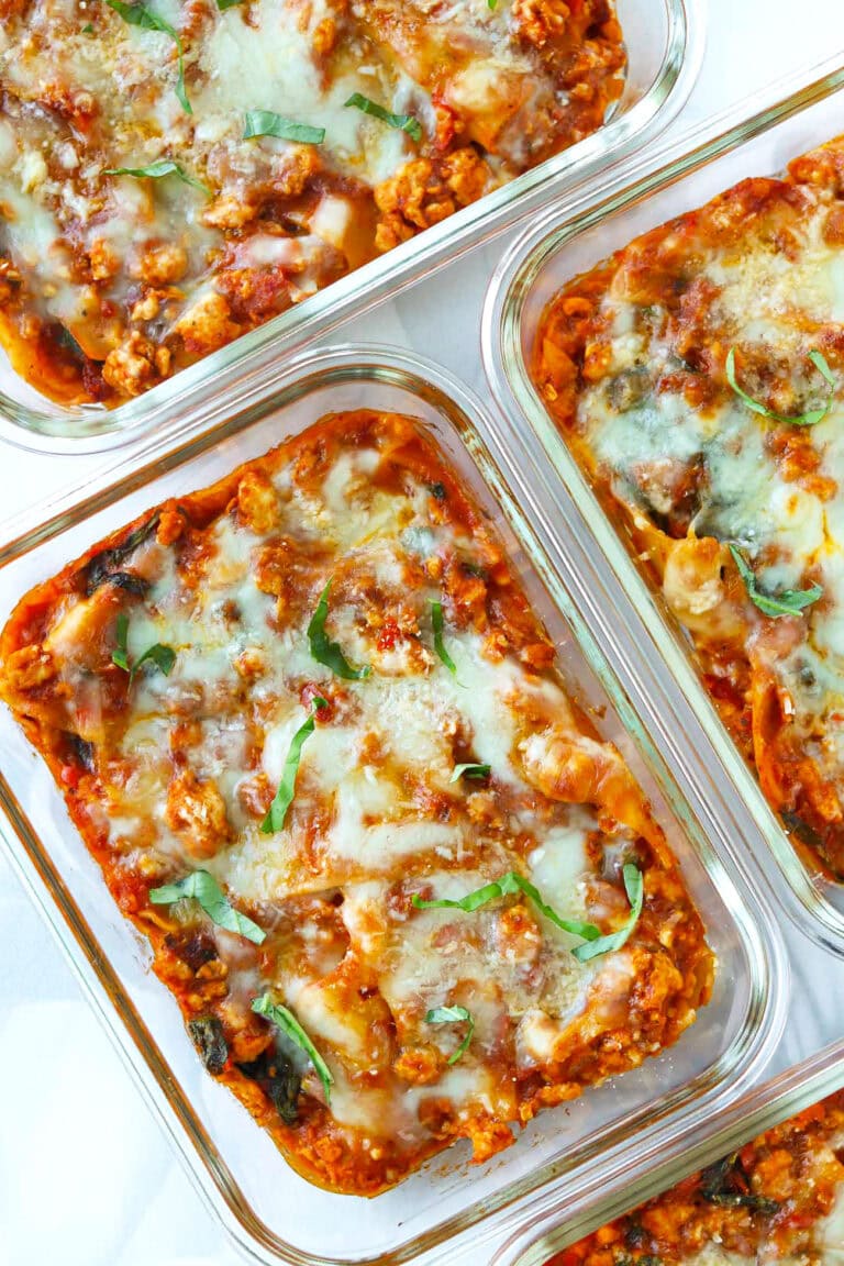 Closeup of skillet vodka sauce lasagna in meal prep containers.
