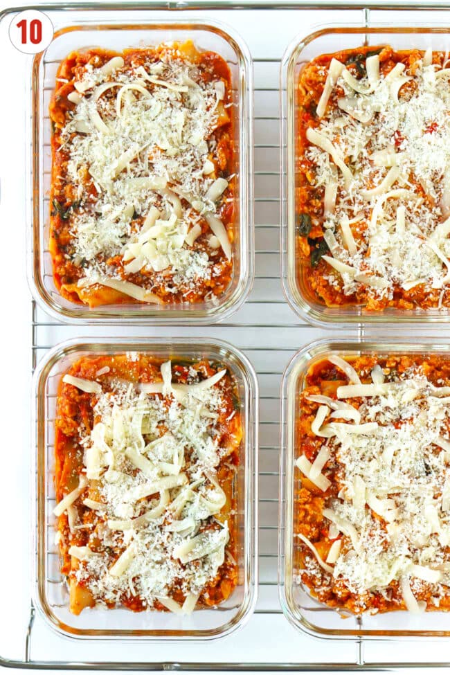 Vodka sauce lasagna topped with shredded mozzarella and parmesan cheese in meal prep containers on a wire rack.