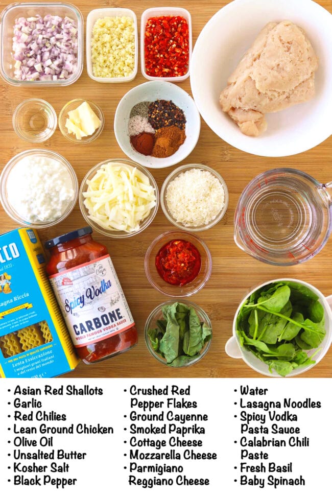 Labeled ingredients for Skillet Vodka Sauce Lasagna on a wood board.