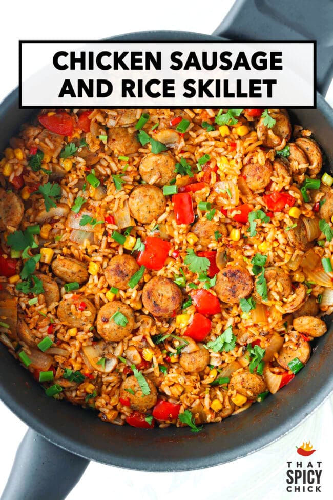 Top view of pan with chicken sausage with rice and veggies. Text overlay "Chicken Sausage and Rice Skillet" and "That Spicy Chick".