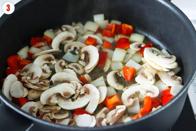 Added sliced mushrooms and chicken broth to skillet with sautéed onion and red bell pepper.