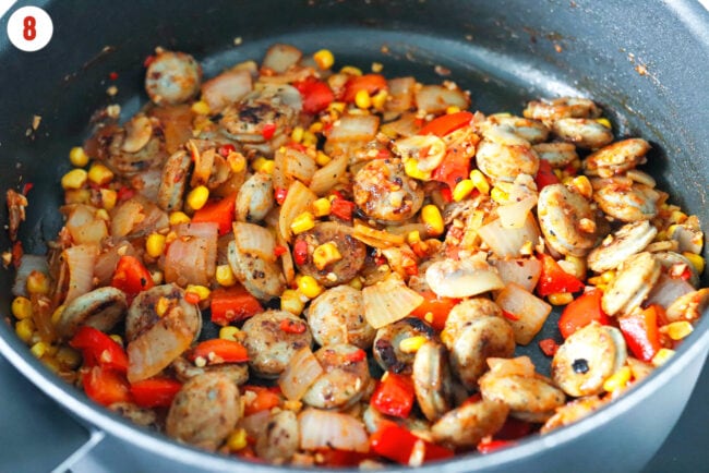 Added cooked chicken sausage to pan with sautéed vegetables.