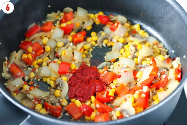 Double concentrated tomato paste to pan with sautéed veggies.
