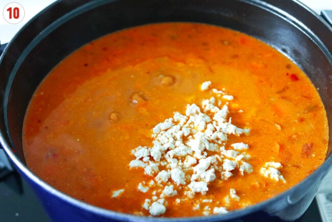Cooked ground chicken added to pot with spicy vodka soup.