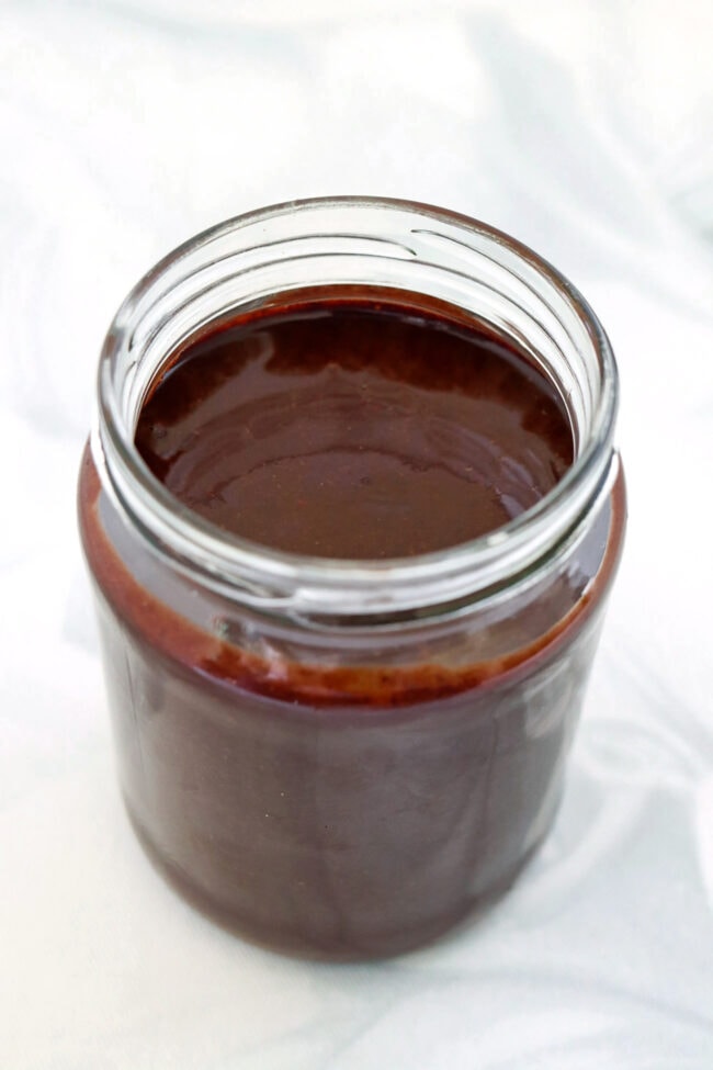 Dark chocolate pecan butter in a glass jar.