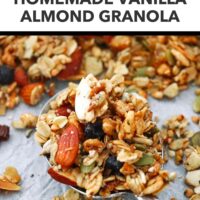 Vanilla granola with almonds on a spoon closeup. Text overlay "Healthy | High Protein", Homemade Vanilla Almond Granola" and "That Spicy Chick".