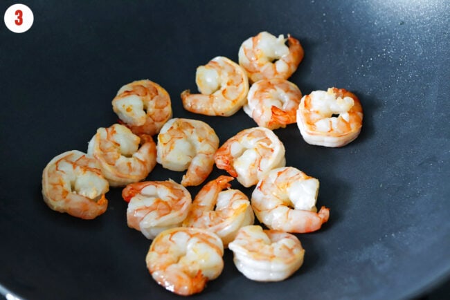 Cooked jumbo shrimp in a wok.