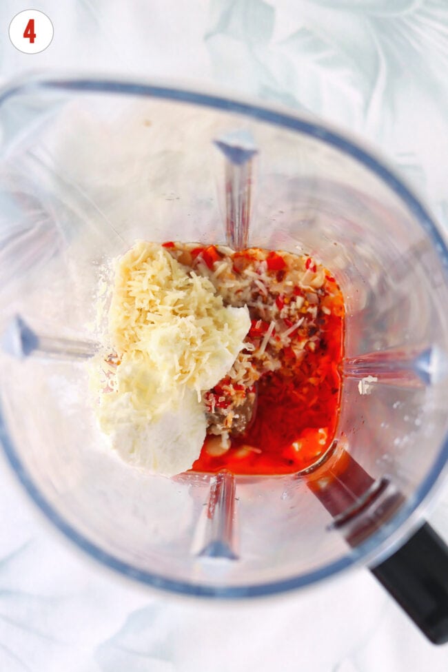 Chili oil, ricotta, parmesan, cannellini beans, sesame oil, and sautéed shallots garlic and chilies in a blender jug.