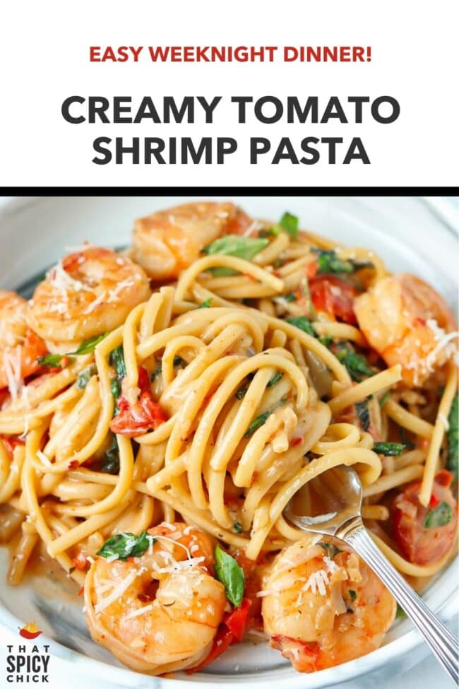 Plate with cream sauce shrimp pasta with cherry tomatoes, spinach, basil topped with grated parmesan. Text overlay "Easy Weeknight Dinner!", "Creamy Tomato Shrimp Pasta", and "That Spicy Chick".