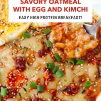 Front view of spoon in a plate of savory oats topped with chili crisp, cheese, green onions, furikake, and a fried egg. Text overlay "Savory Oatmeal with Egg and Kimchi", "Easy High Protein Breakfast" and "That Spicy Chick".