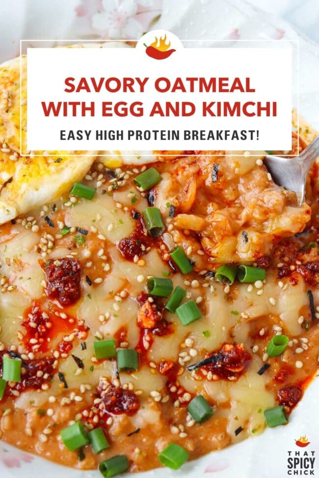 Front view of spoon in a plate of savory oats topped with chili crisp, cheese, green onions, furikake, and a fried egg. Text overlay "Savory Oatmeal with Egg and Kimchi", "Easy High Protein Breakfast" and "That Spicy Chick".