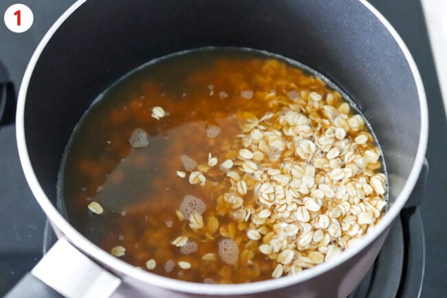 Pot with rolled oats and chicken bone broth.