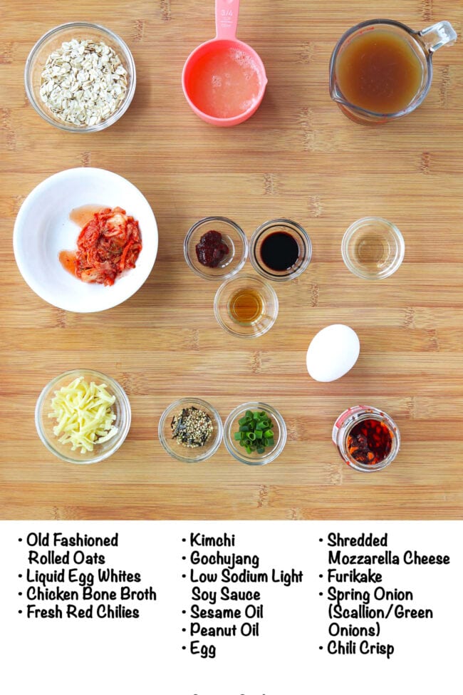 Labeled ingredients for savory oatmeal with egg and kimchi on a wood board.