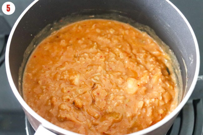 Sesame oil added to pot with creamy kimchi savory oatmeal.