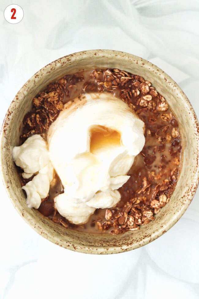Oats, cocoa powder, chia seeds with high protein yogurt and pancake syrup in a bowl.