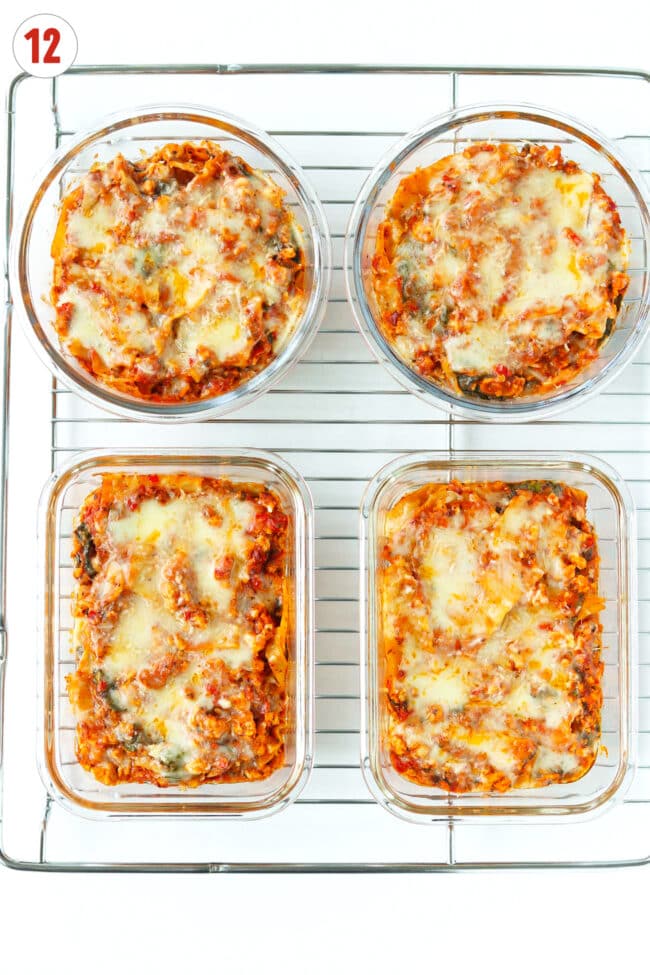 Baked skillet red pesto lasagna with melted mozzarella cheese and parmesan in meal prep containers on a wire rack.
