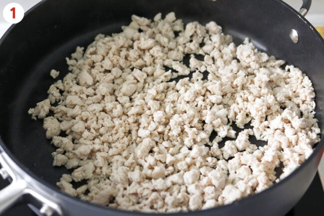 Cooked ground chicken breast in a large skillet.