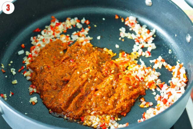 Red pesto added to pan with sautéed shallots, garlic and red chilies.