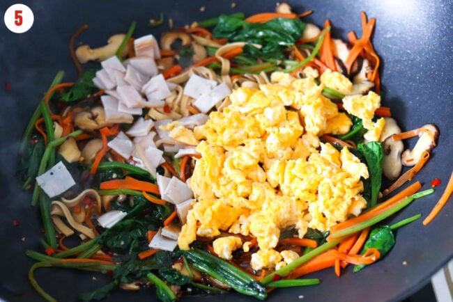 Scrambled eggs and chopped deli turkey breast added to wok with stir-fried tofu noodles and vegetables.