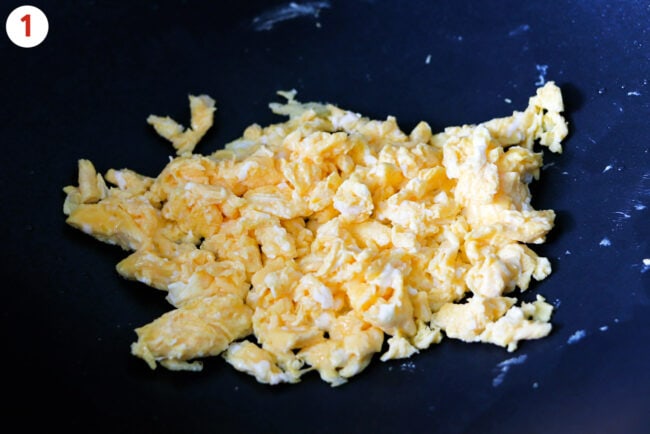 Scrambled eggs in a large wok.