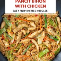 Pancit bihon with chicken and vegetables in wok. Text overlay "Pancit Bihon with Chicken" and "Easy Filipino Rice Noodles!".