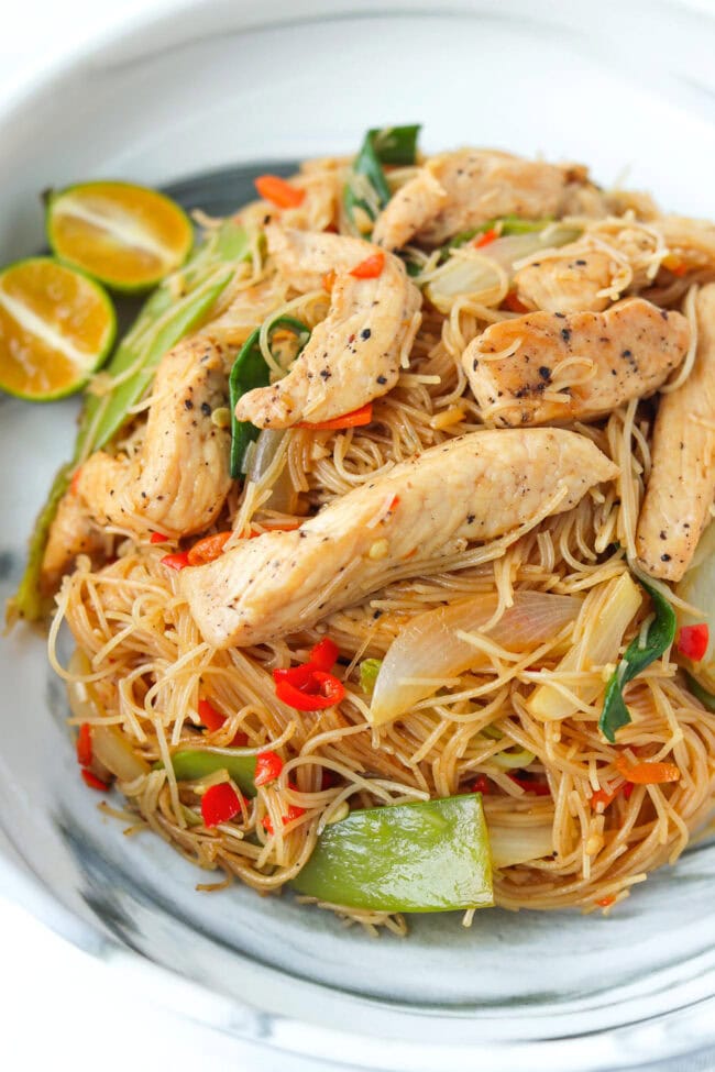Closeup front view of plate with pancit bihon with chicken.