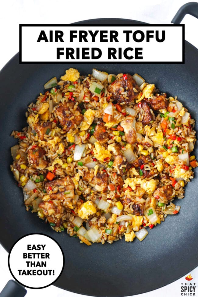 Air fryer tofu fried rice with scrambled eggs and vegetables in a wok. Text overlay "Air Fryer Tofu Fried Rice", "Easy", "Better Than Takeout!" and "That Spicy Chick".