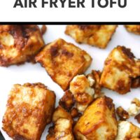 Closeup front view of air fryer tofu nuggets on a plate. Text overlay "Quick and Easy!" and "Air Fryer Tofu".