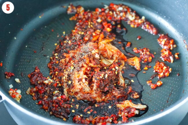 Kimchi, soy sauce and seasonings added to pan with sautéed garlic, chilies and shallots.