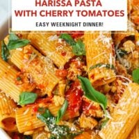 Plate with harissa and cherry tomato pasta with spinach and basil topped with parmesan. Text overlay "Harissa Pasta with Cherry Tomatoes", "Easy Weeknight Dinner!" and "That Spicy Chick".