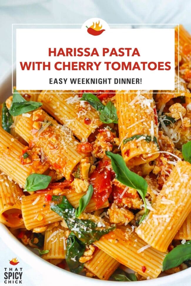 Plate with harissa and cherry tomato pasta with spinach and basil topped with parmesan. Text overlay "Harissa Pasta with Cherry Tomatoes", "Easy Weeknight Dinner!" and "That Spicy Chick".