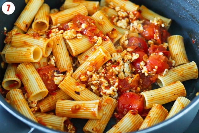 Harissa pasta with cherry tomatoes and ground chicken in a pan.