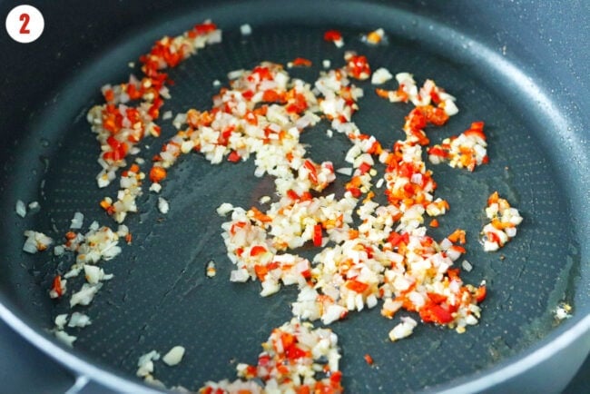 Pan with sautéed finely minced shallots, garlic and red chilies.