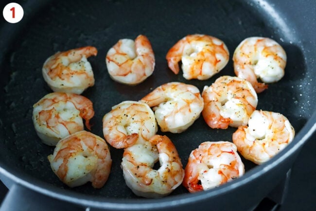 Seared shrimp in a skillet.