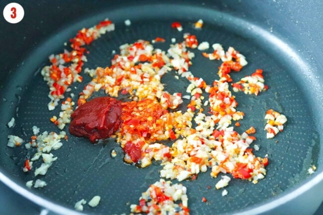 Calabrian chili sauce and double concentrated in a pan with sautéed finely minced shallots, garlic and red chilies.