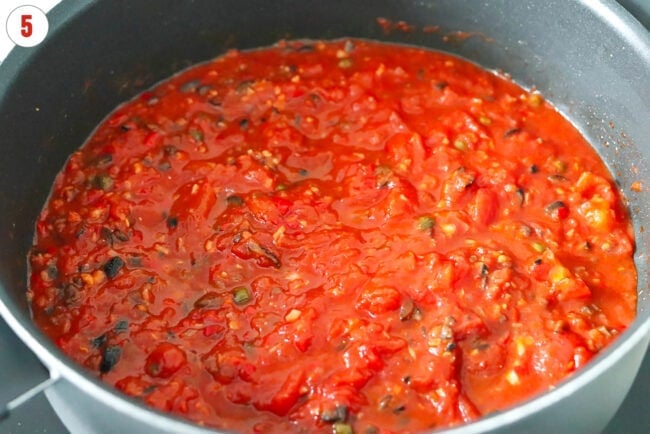 Spicy tomato sauce with capers, black olives and anchovies in a skillet.