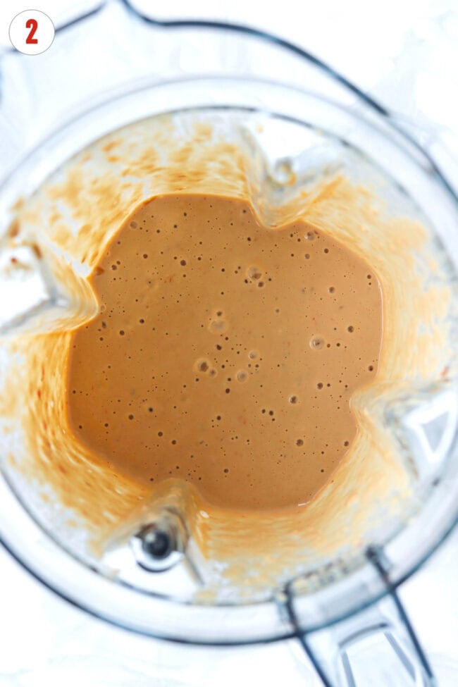 Blender with creamy silken tofu tahini and peanut butter sauce.