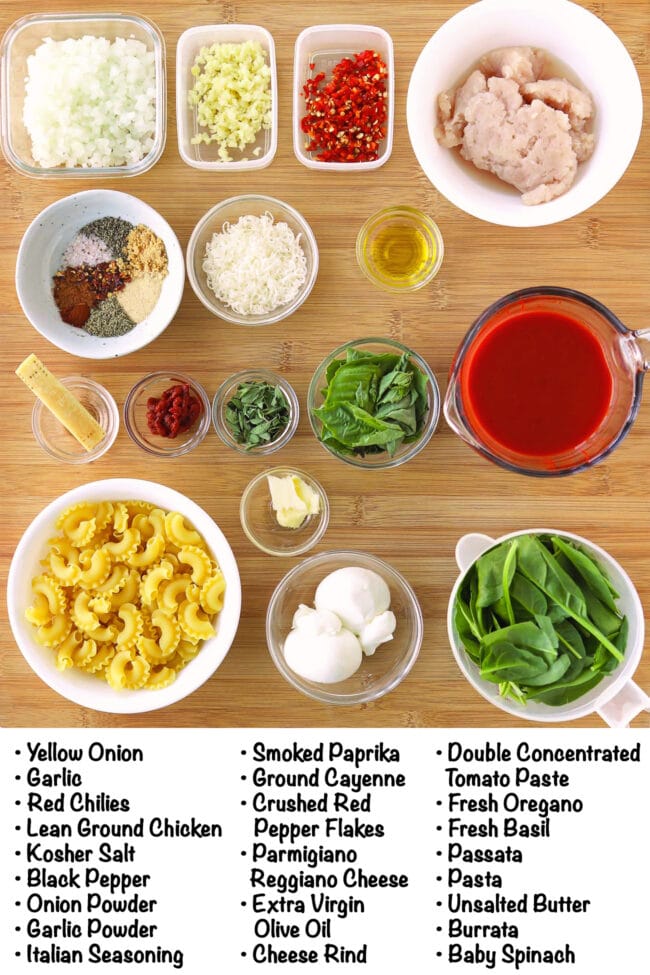 Labeled ingredients for Tomato Basil Pasta with Burrata on a wood board.